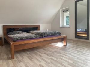 a bedroom with a wooden bed in a room at Gästehaus Lauerwald in Niesky