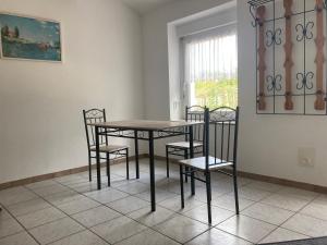 Niesky的住宿－Gästehaus Lauerwald，窗户客房内的桌椅