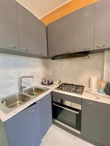 a kitchen with a sink and a stove at Nido dei Cigni in Turin +20 photos