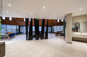 a lobby of a building with tables and chairs at شقق ممسى المخدومة in Riyadh