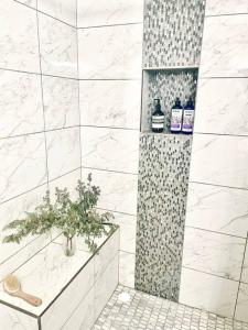 a bathroom with a shower with a plant in it at Gorgeous Serene Gated Newly Remodeled Townhouse in Las Vegas
