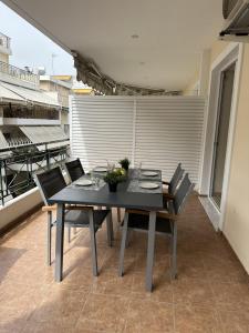 a black table and chairs on a balcony at LY Deluxe Apartment Athens in Athens