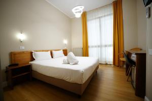 Postel nebo postele na pokoji v ubytování Hotel Montevecchio