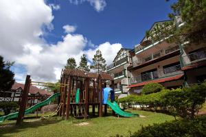 a playground with a slide in a park at BC Homestay @ Equatorial Hill Apartment in Brinchang