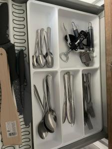 a drawer with silver utensils in it at La Mia Casa Apartament Świdnica in Świdnica