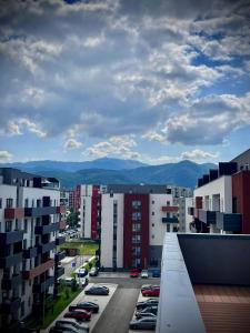 a view of a city with cars parked in a parking lot at Blue Boho Studio Brasov with Terrasse and Panoramic view in Braşov