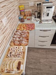 a counter with many different types of pastries on it at B&B EDEN OGLIASTRA in Tortolì