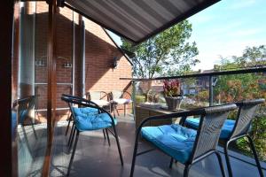 Un patio con sillas y una mesa en el balcón. en Costa Del Katwijk, en Katwijk aan Zee