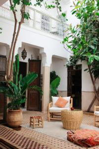 a living room with a couch and some trees at Riad Dar Nael in Marrakech