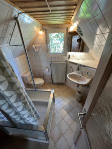 a small bathroom with a sink and a staircase at Ferienwohnung Obermühle in Alter Graben