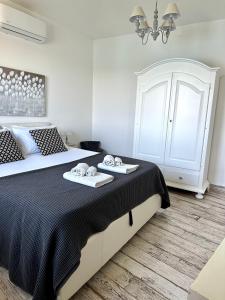 a bedroom with a large bed with two towels on it at Il bianconido in Castel Gandolfo