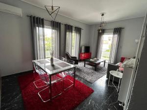 a living room with a table and a red rug at Beautiful apartment next to metro station in Athens