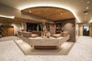 a lobby with a reception desk in a building at Hotel Das Walchsee in Walchsee