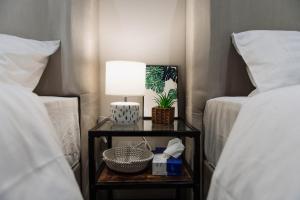 a nightstand with a lamp on it next to two beds at Elite in Riyadh
