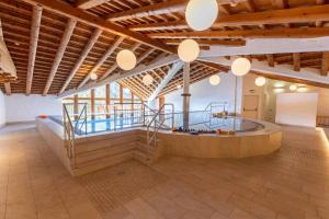 a large indoor swimming pool in a large building at Das Hopfgarten Familotel Tirol in Hopfgarten im Brixental