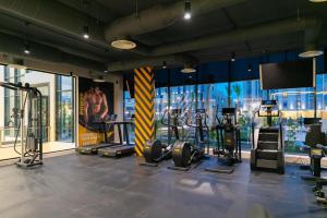 a gym with several tread machines and a large window at Elite in Riyadh