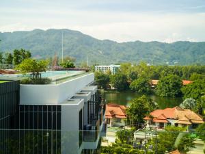 an external view of a building with a river at Skypark Laguna Rooftop Pool Apartment near Bang Tao Beach in Bang Tao Beach +65 photos