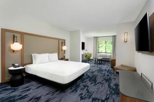 a hotel room with a bed and a television at Fairfield by Marriott Luquillo Beach in Luquillo
