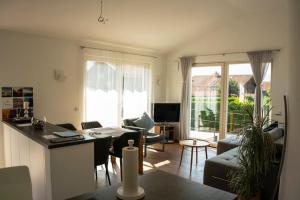 uma sala de estar com uma cozinha e uma sala de estar com uma mesa em Kleine Auszeit em Unterwössen