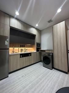 duża kuchnia z pralką i suszarką w obiekcie Modern Appartements With Private Entry w Rijadzie