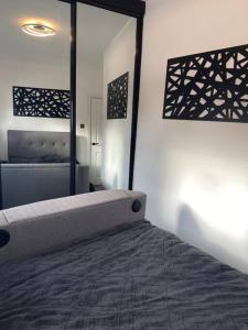 a bedroom with a bed and a large mirror at Modern 1 bed town centre apartment in Tamworth in Tamworth