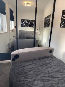 a bedroom with a bed and a large mirror at Modern 1 bed town centre apartment in Tamworth in Tamworth