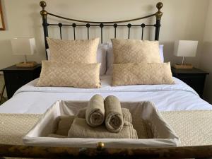 a bed with two towels in a bath tub at Hidden gem in heart of Breckland in Watton