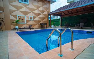 Presken Waters في لاغوس: مسبح في فندق يوجد به طاولات وكراسي