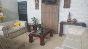 a living room with a couch and a coffee table at Pousada Boqueirão in Passo Fundo