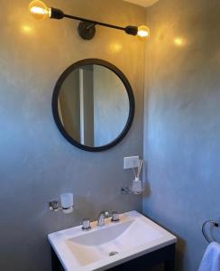 a bathroom with a sink and a mirror at La Cabaña in Puerto Madryn