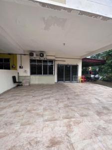 a large empty garage with a car parked in it at Azlina Homestay Jerantut in Jerantut