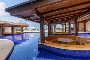 a swimming pool with a resort with blue water at Villa Cala Marina + Jacuzzi in Colón