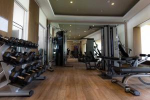 a gym with treadmills and ellipticals in a building at Villa Cala Marina + Jacuzzi in Colón