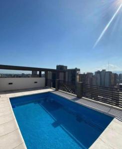a swimming pool on the roof of a building at Aires del Norte Apart in San Miguel de Tucumán