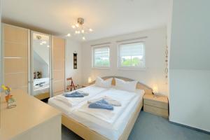 a small bedroom with a bed and a mirror at Ferienhaus Anja 3 in Ueckeritz