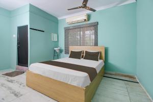 En eller flere senge i et værelse på OYO Flagship 81246 Hotel Palm Exotica