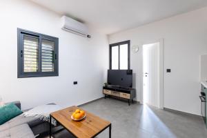a living room with a couch and a table at Luxury Central Old Town Apartment in Beer Sheva