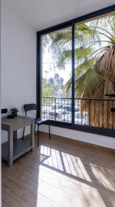 a room with a table and a large window at Luxury Central Old Town Apartment in Beer Sheva