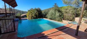 a swimming pool with a view of the mountains at El Racó dels Mussols 2 in Adri