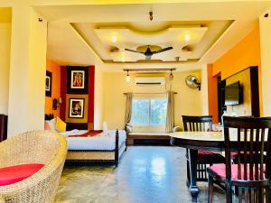 a bedroom with a bed and a table and chairs at Udai Valley Resort- Top Rated Resort in Udaipur with mountain view in Udaipur