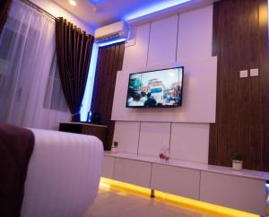 a living room with a flat screen tv on a wall at Presken Waters in Lagos