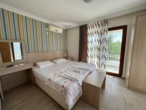a bedroom with a large bed and a window at MİDİS PARK OTEL Şarköy in Şarköy