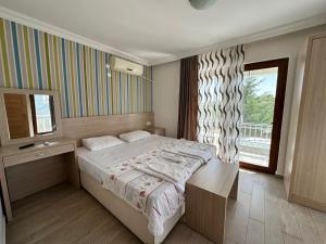 a bedroom with a large bed and a window at MİDİS PARK OTEL Şarköy in Şarköy