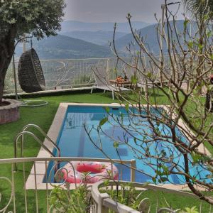 a swimming pool with a view of the mountains at Gardenia in ‘Ein el Asad