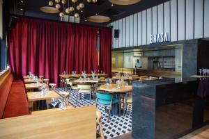 a restaurant with wooden tables and a red curtain at Central 2 Bed Apartment in Cantonments