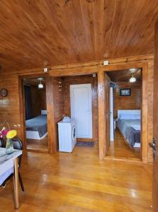 a large room with two beds and a wooden ceiling at Racha Nanida in Agara