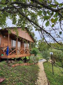a wooden house with a pathway leading to it at Racha Nanida in Agara +44 photos