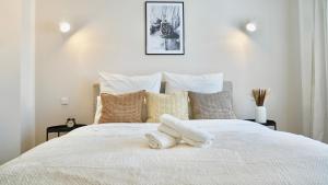 een slaapkamer met een wit bed en 2 handdoeken bij Luxuriös & Sehr Zentral in Wuppertal in Wuppertal