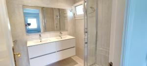 a bathroom with a sink and a glass shower at Mundaka Sea Flat in Mundaka +55 photos