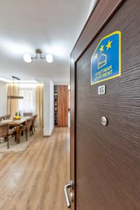 a door in an office with a sign on it at Apartman Gačanović Lux in Zlatibor